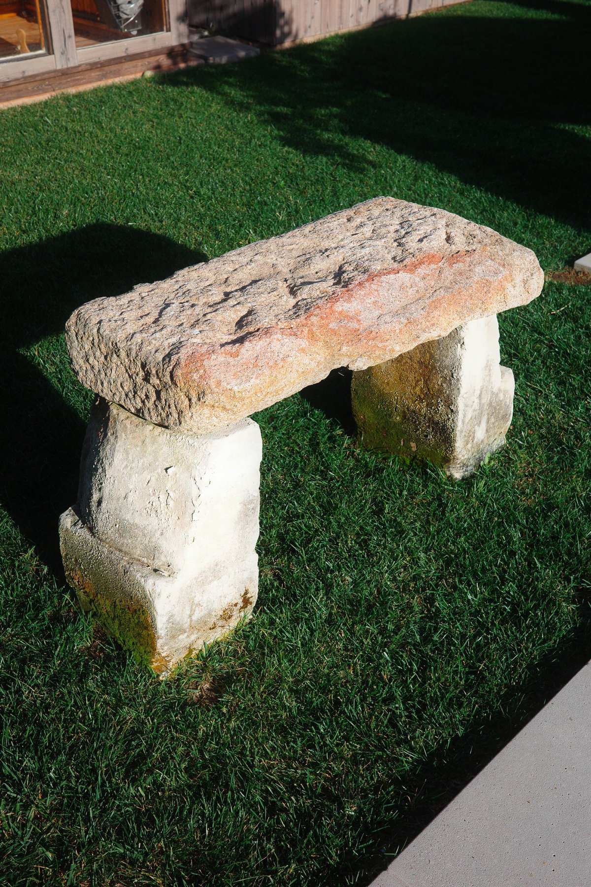 Carved stone bench on the lawn